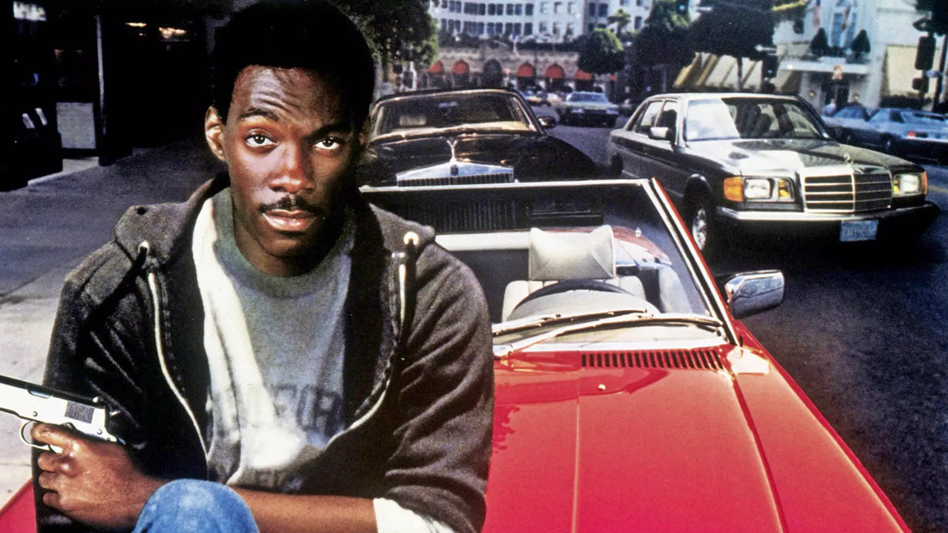 ادی مورفی روی یک ماشین قرمز در فیلم Beverly Hills Cop